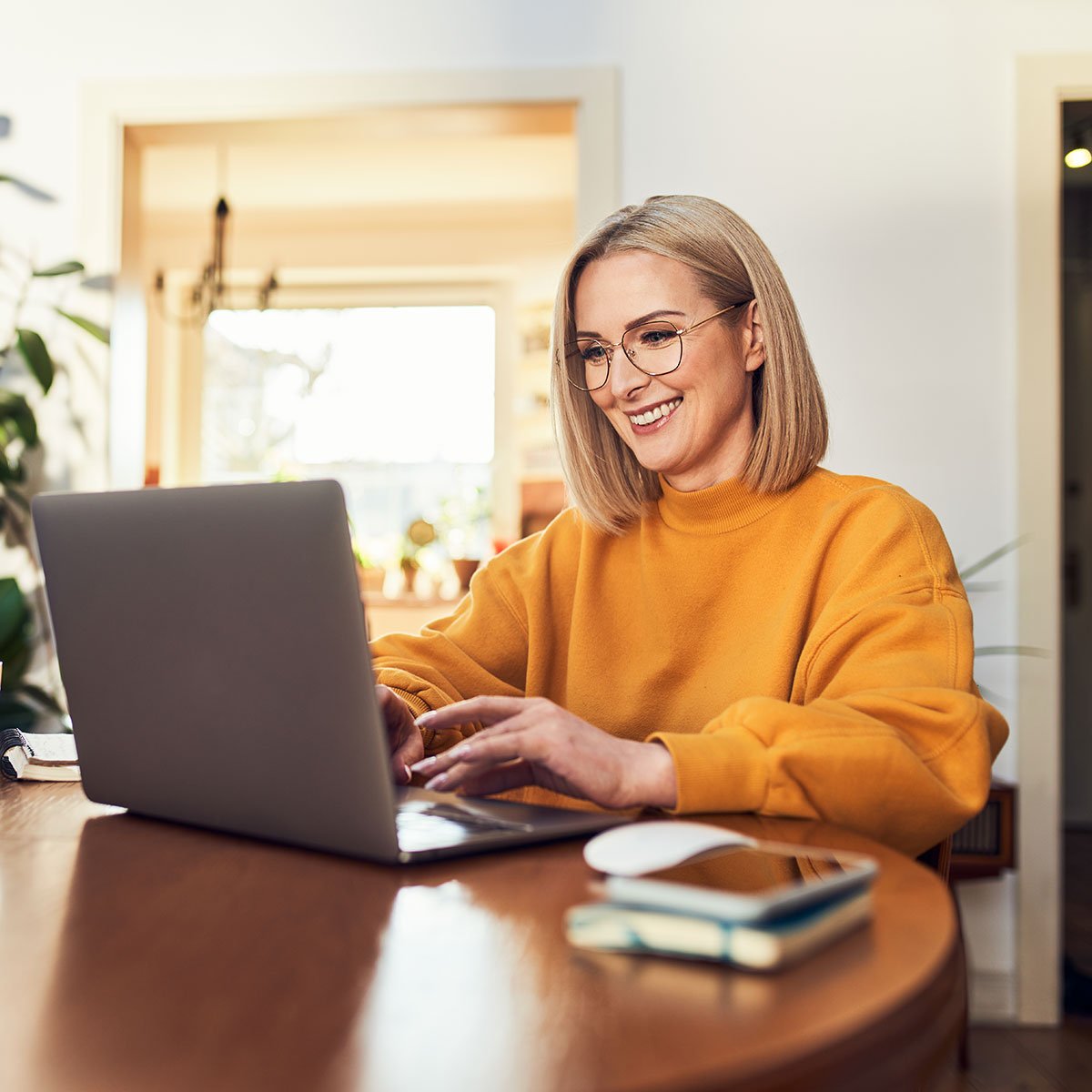 Woman on computer after signing up for a first time homebuyer savings account with CCCU