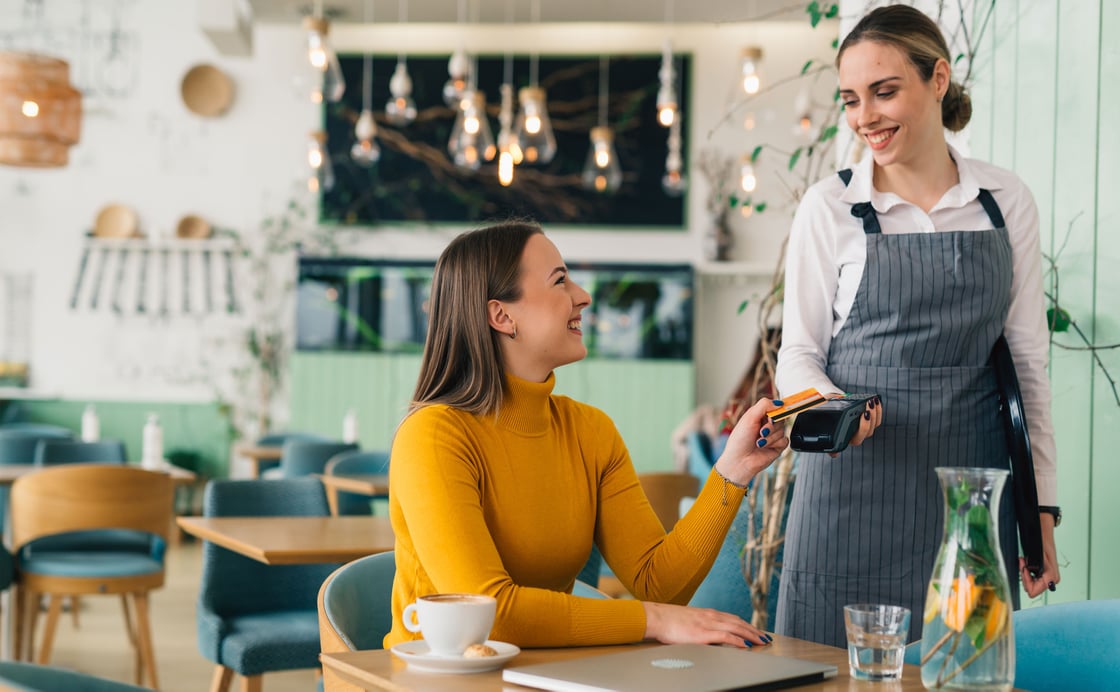 Using the tap feature to pay for lunch at a cafe using the contactless debit card with CCCU.